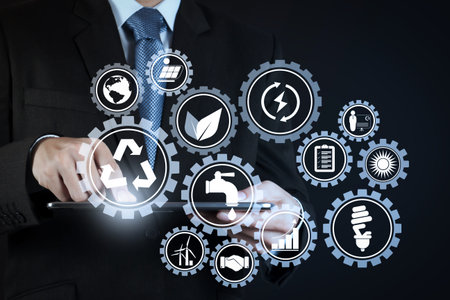 Sustainable development with icons of renewable energy and natural resources preservation with environment protection inside connected gears.businessman hand using tablet computer.の写真素材