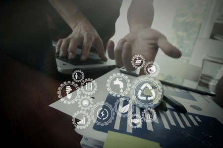 Sustainable development with icons of renewable energy and natural resources preservation with environment protection inside connected gears.businessman showing texture world on business document.のeditorial素材