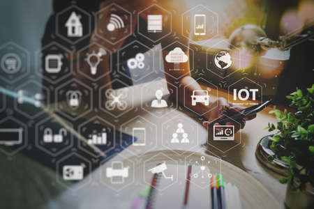 Internet of Things (IOT) technology with AR (Augmented Reality) on VR dashboard. Man using VOIP headset with digital tablet computer docking smart keyboard, concept communication, it support, call center の写真素材