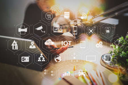 Internet of Things (IOT) technology with AR (Augmented Reality) on VR dashboard. Man using VOIP headset with digital tablet computer docking smart keyboard, concept communication, it support, call center の写真素材