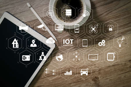 Internet of Things (IOT) technology with AR (Augmented Reality) on VR dashboard. Coffee cup and Digital table dock smart keyboard,eyeglasses,stylus pen on wooden table,filter effectの写真素材