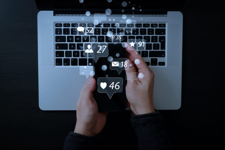 Social media and Marketing virtual icons screen concept.cyber security internet and networking concept.Businessman hand working mobile phone on laptop computer backgroundの写真素材
