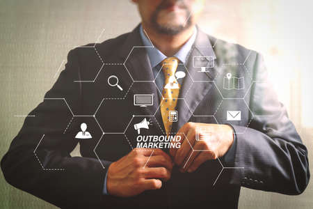 Outbound marketing business virtual dashboard with Offline or interruption marketing.Businessman adjusting tie,Front view, no head. Concept of working in an office.filter effectの写真素材