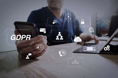 GDPR. Data Protection Regulation with Cyber security and privacy virtual diagram.designer using smart phone and keyboard dock digital tablet.Worldwide network connection technology interface.on marble desk.の写真素材