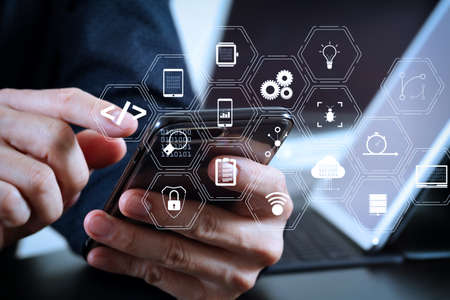 Coding software developer work with augmented reality dashboard computer icons of scrum agile development and code fork and versioning with responsive cybersecurity.businessman hand working with smart phone.の写真素材