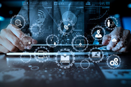 E-learning with connected gear cogs connected diagram virtual dashboard.business man hand working on...