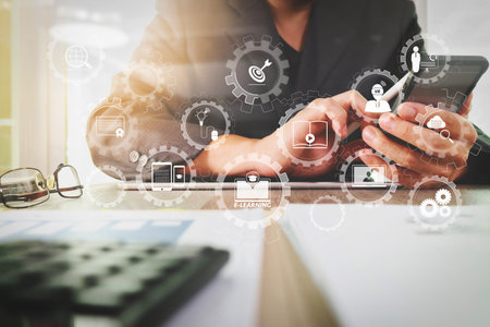 E-learning with connected gear cogs connected diagram virtual dashboard.business documents on office...