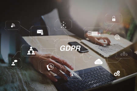 GDPR. Data Protection Regulation with Cyber security and privacy virtual diagram.Website designer working digital tablet dock keyboard and computer laptop with smart phone and graphics design diagram.の写真素材