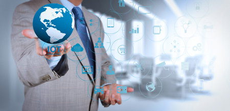 Internet of Things (IOT) technology with AR (Augmented Reality) on VR dashboard. businessman holding...