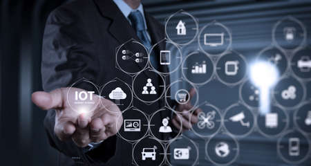 Internet of Things (IOT) technology with AR (Augmented Reality) on VR dashboard. Businessman hand working with a digital tablet on meeting room backgroundの写真素材