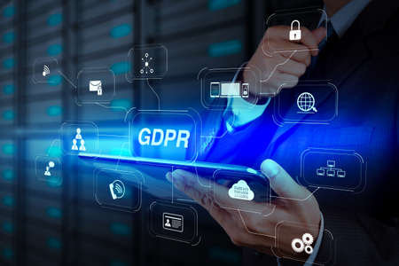 GDPR. Data Protection Regulation with Cyber security and privacy virtual diagram.businessman hand using tablet computer and server room backgroundの写真素材
