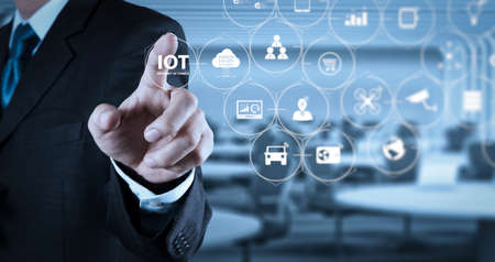 Internet of Things (IOT) technology with AR (Augmented Reality) on VR dashboard. Businessman hand pressing an imaginary button on virtual screenの写真素材