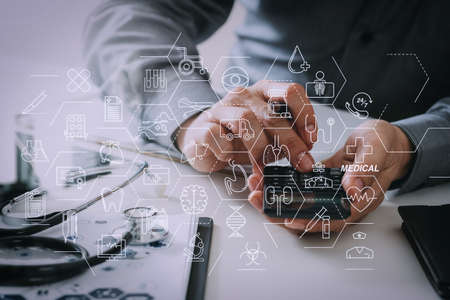 Health care and medical services concept with flat line AR interface.Healthcare costs and fees concept.Hand of smart doctor used a calculator for medical costs in modern hospitalの写真素材