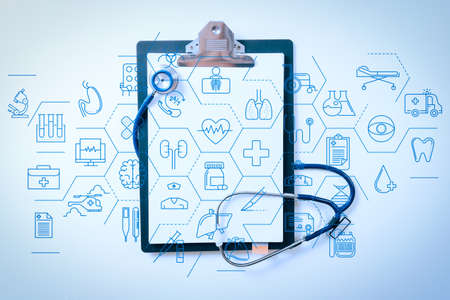 Health care and medical services concept with flat line AR interface. stethoscope and gray clipboard on white desk backgroundの写真素材