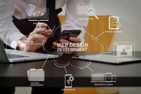 Developing programming and coding technologies with Website design in virtual diagram.businessman working with smart phone and digital tablet and laptop computer on wooden desk in modern officeの写真素材