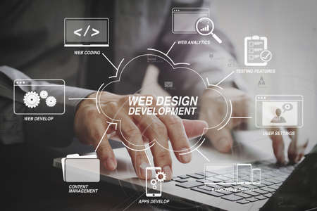 Developing programming and coding technologies with Website design in virtual diagram.businessman working with laptop computer on wooden desk in modern office with virtual icon diagramの写真素材