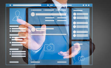 Web page browser of Social media Page VR Interface on the laptop computer.Businessman hand pressing an imaginary button on virtual screenの写真素材