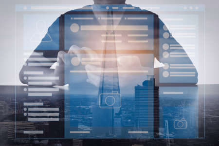 Web page browser of Social media Page VR Interface on the laptop computer.Double exposure of success businessman using smart phone with London building,city.の写真素材