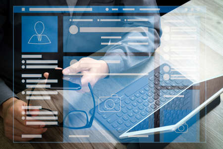 Web page browser of Social media Page VR Interface on the laptop computer.businessman hand using smart phone,mobile payments online shopping,omni channel,digital tablet docking keyboard computer.の写真素材