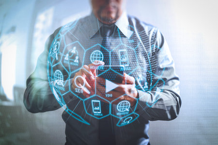 Digital marketing media (website ad, email, social network, SEO, video, mobile app) in virtual globe shape diagram.success businessman using smart phone ,front view,filter effectの写真素材