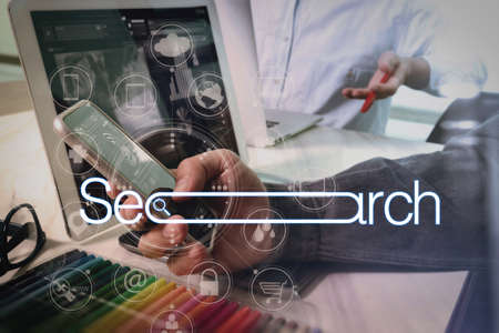 Searching Browsing Internet Data Information Networking Concept with blank search bar.Designer Businessman hand using smart phone,mobile payments online shopping with computer in modern office.の写真素材