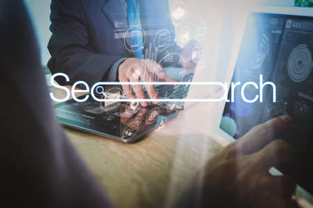 Searching Browsing Internet Data Information Networking Concept with blank search bar.Designer Businessman hand using smart phone,mobile payments online shopping with computer in modern office.の写真素材