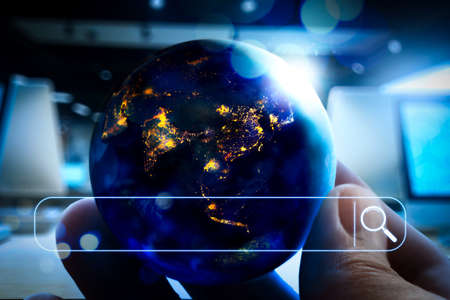 Searching Browsing Internet Data Information Networking Concept with blank search bar.Earth at night was holding in human hands for Earth day and Energy saving conceptの写真素材