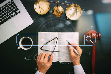 Searching Browsing Internet Data Information Networking Concept with blank search bar.justice and law concept.Top view of Male judge hand in a courtroom with the gavel and brass scale and computer.の写真素材