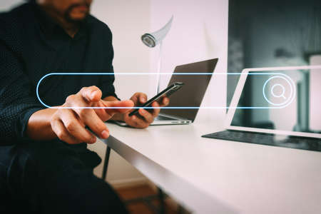 Searching Browsing Internet Data Information Networking Concept with blank search bar.businessman working with smart phone and digital tablet and laptop computer in modern officeの写真素材