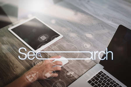 Searching Browsing Internet Data Information Networking Concept with blank search bar.Designer Businessman hand using smart phone,mobile payments online shopping with digital tablet docking keyboard computer.の写真素材