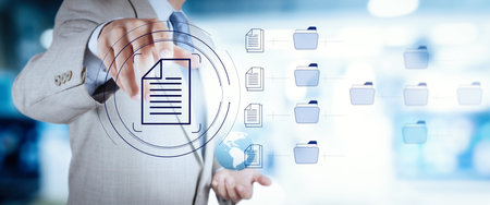 Businessman workimn Document Management System (DMS),Virtual online documentation database and process automation to efficiently manage files, knowledge and documentation in enterprise with ERP.の写真素材