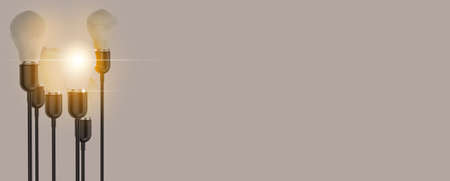 Glowing Light Bulb between the others on yellow light background. Leadership, innovation, great idea and individuality concepts. 3d rendering.の写真素材