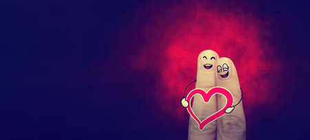 the happy vintage  finger couple in love with painted smiley classic banner.の写真素材