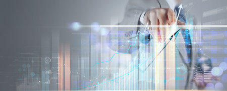 Businessman working with modern computer virtual dashboard analyzing innovation finance sales data and economic growth graph chart and block chain technology.の写真素材
