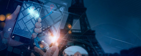 Tourist Hand holding a smartphone which displays Ui city map with Eiffel tower,PARIS, FRANCE background.の写真素材