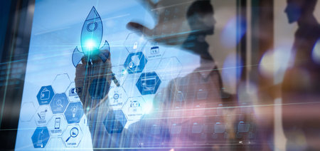 Businessman working on modern computer showing Startup concept with icon business and network connection on modern virtual dashboard.の写真素材