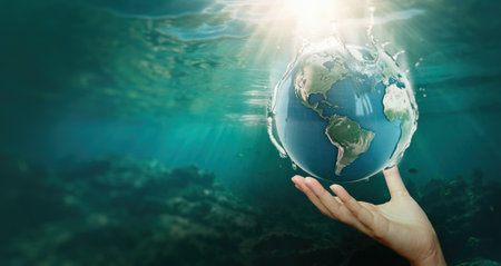 hand holding the planet earth underwater,Save water concept, world water day.の写真素材