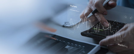 close up Businessmen work with stock market investments using calcurator to analyze trading data. smartphone with stock exchange graph on screen. Financial stock market.の写真素材