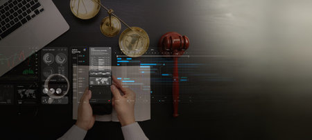 Law and justice concept. Judge using smartphone for jusice data analysis business law,Judge hammer with the dollar placed - concept of judgment and justice. About fraud tax finesの写真素材