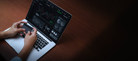 Cyber Digital banking internet payment online shopping and financial technology concepts, Businessman use laptops and hold credit card pay via mobile banking for online finance investment.の写真素材