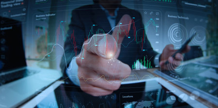Businessman pointing finger to growth success finance business chart and Analyzing sales data, Economy growth financial data concept and investment market profit, Stock market, Strategy and planningの写真素材