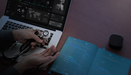 Confident female doctor, therapist sitting at desk with medical stethoscope Using a laptop and...