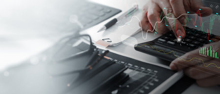 Businessman using calculator with marketing data growth graph and progress of business and analyzing financial and investment information, business planning and strategy.の写真素材