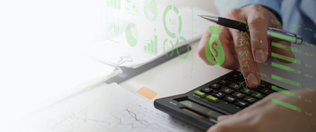 Business accounting concept, Business man using calculator with computer laptop, budget and loan paper in office.の写真素材
