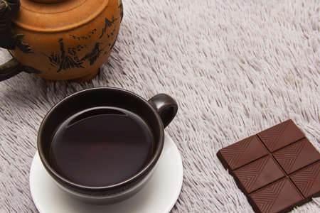 Chocolate and a Cup of tea on a gray background.の写真素材