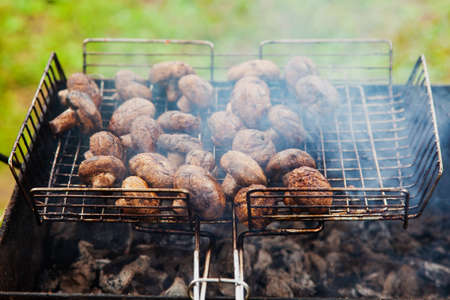 The mushrooms on the grill, ready to serve, rest in the fresh air in the summer.の写真素材