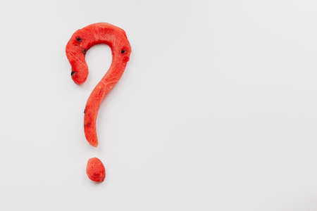 Watermelon, a question mark carved from a watermelon on a white background.の写真素材