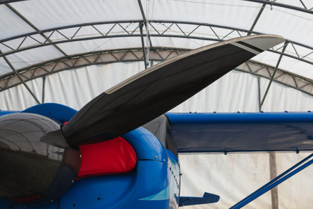 Blue private plane in the hangar, black plastic blade close-up. Bush pilot.