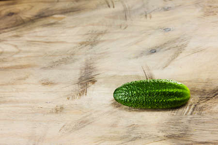 Cucumber on the gray wood textured background, fresh vegetables, summer in the garden.の写真素材