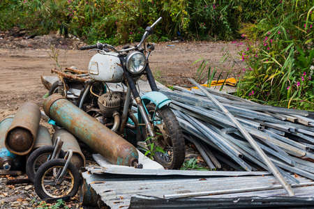 Old motorcycle on the background of oxygen cylinders, Scrap yard, metal for recycling.の写真素材